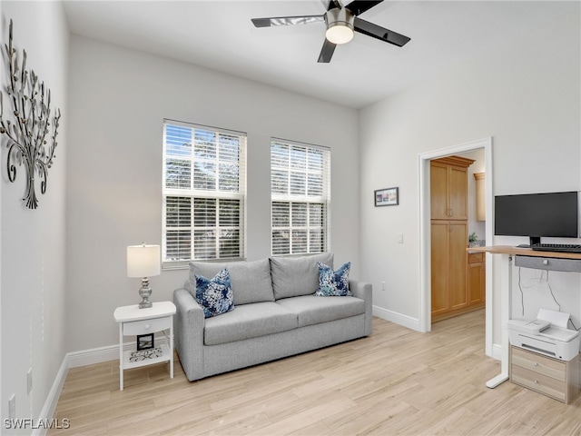 living room featuring ceiling fan and light hardwood / wood-style flooring