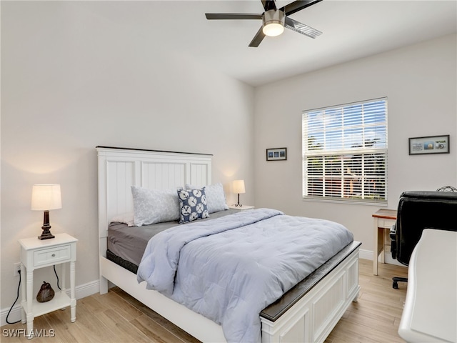 bedroom with ceiling fan and light hardwood / wood-style floors