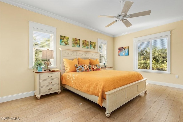 bedroom with light wood-type flooring, multiple windows, ornamental molding, and ceiling fan