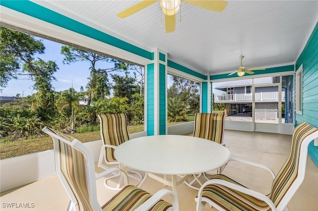 sunroom / solarium with plenty of natural light and ceiling fan