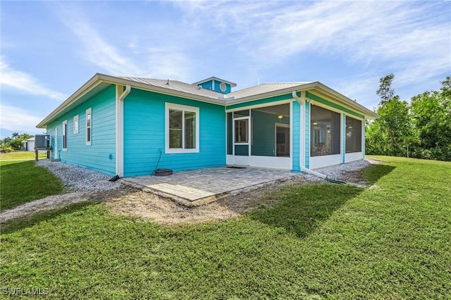 back of house with a yard, a patio area, and a sunroom