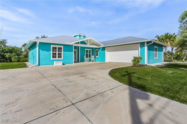 ranch-style house featuring a garage and a front yard