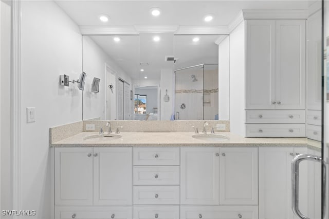 bathroom featuring vanity and a shower with door