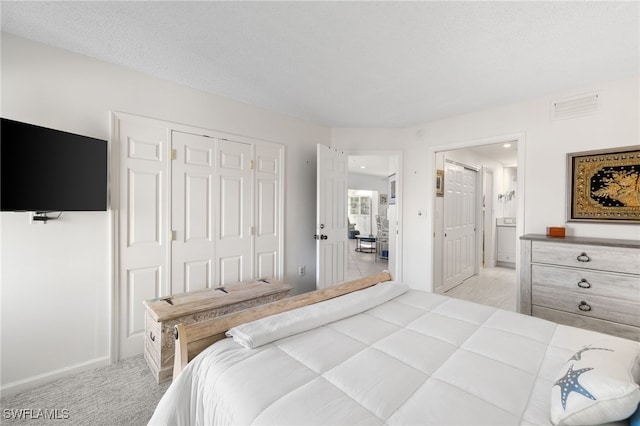 carpeted bedroom featuring a closet and a textured ceiling