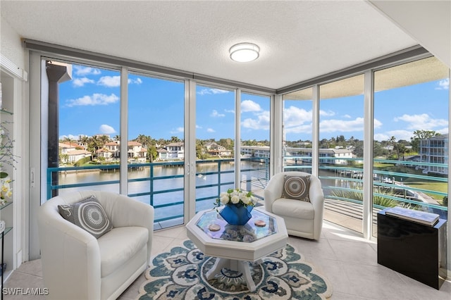 sunroom / solarium featuring a water view