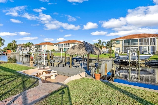 dock area featuring a lawn and a water view