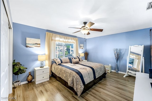 bedroom with light hardwood / wood-style flooring and ceiling fan