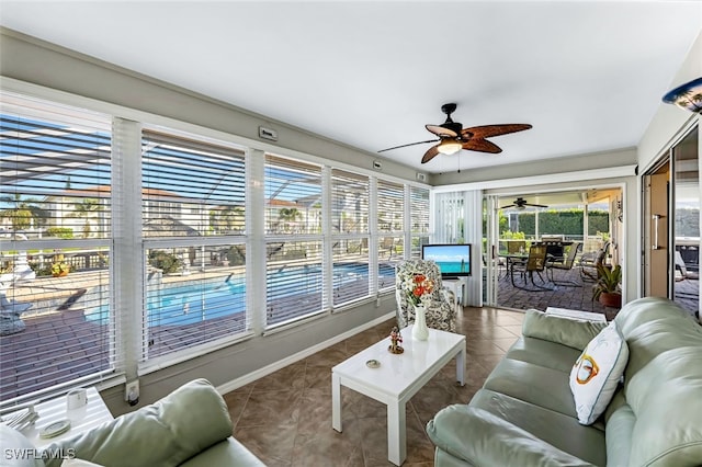 sunroom / solarium featuring ceiling fan