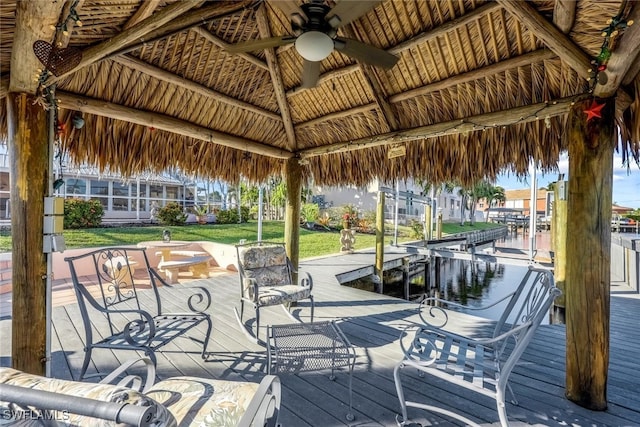 deck with a gazebo, ceiling fan, and a boat dock