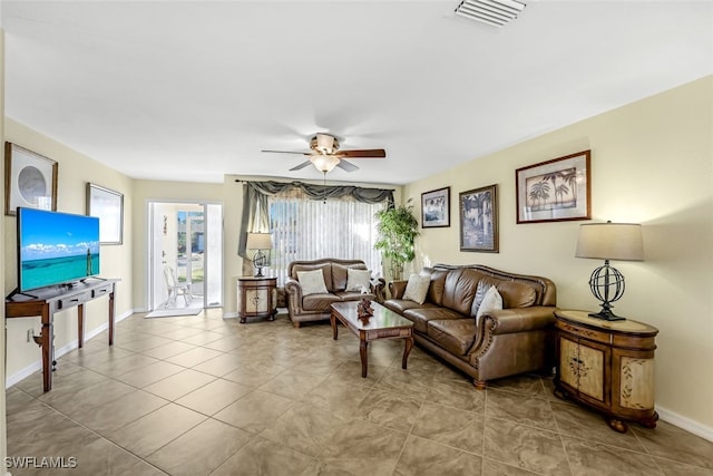 living room with ceiling fan and light tile patterned flooring