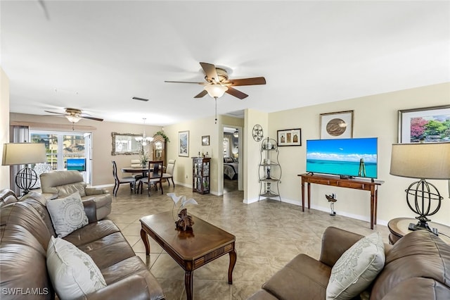 living room with ceiling fan with notable chandelier