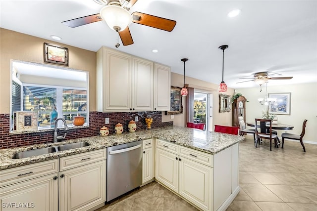 kitchen with stainless steel dishwasher, a healthy amount of sunlight, sink, and cream cabinetry