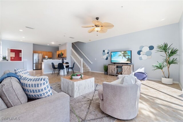 tiled living room featuring ceiling fan