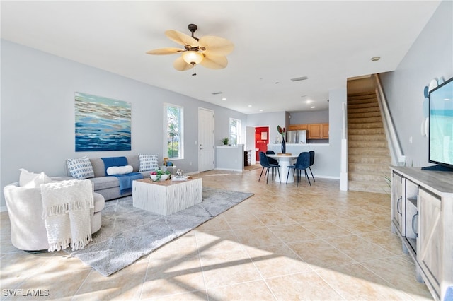 living room with ceiling fan and light tile patterned floors