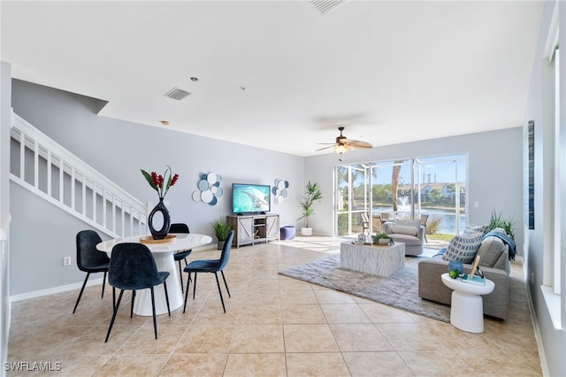 interior space with ceiling fan and light tile patterned flooring