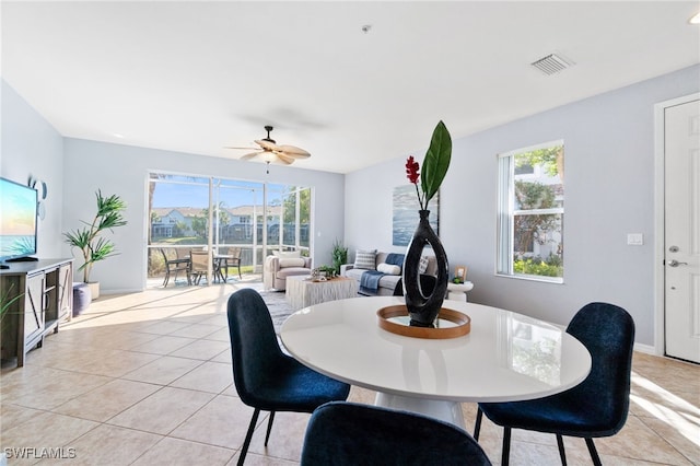 tiled dining room with ceiling fan