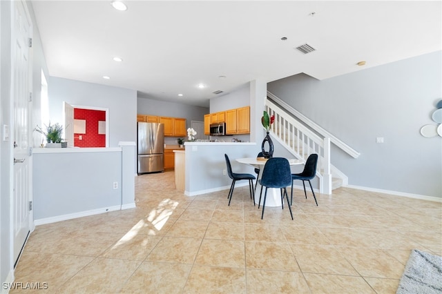 dining area with light tile patterned floors