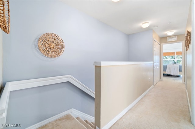 corridor with light colored carpet