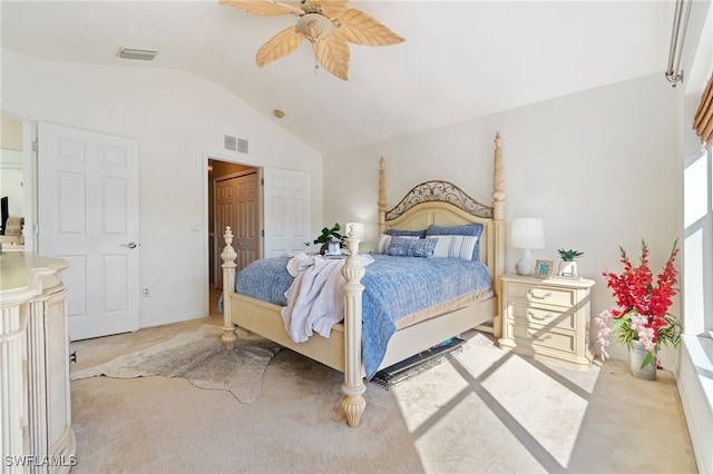 bedroom featuring ceiling fan, light colored carpet, and lofted ceiling