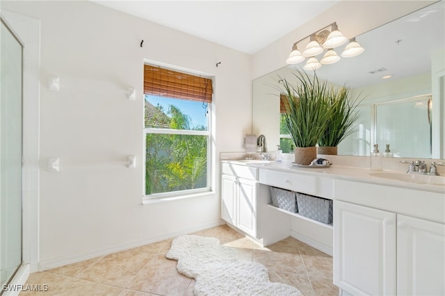 bathroom featuring tile patterned flooring, vanity, and a shower with shower door