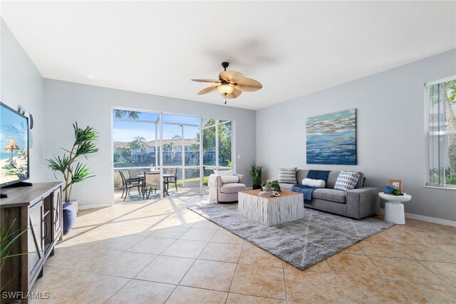 living room with light tile patterned floors, ceiling fan, and a healthy amount of sunlight