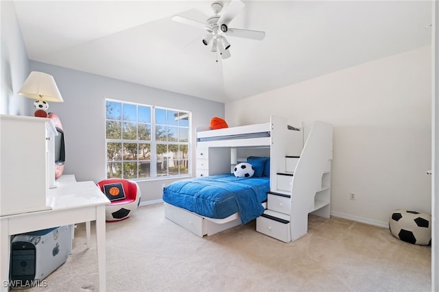 bedroom featuring ceiling fan, lofted ceiling, and light carpet