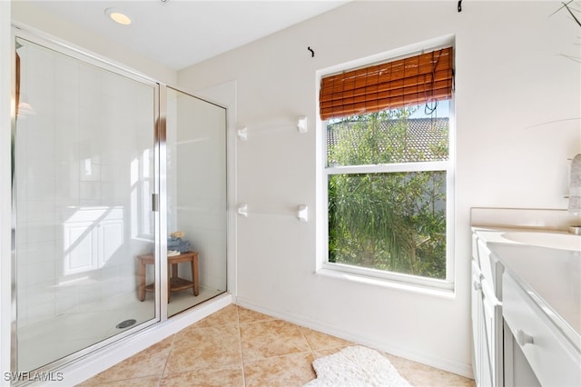 bathroom with tile patterned flooring, walk in shower, and a wealth of natural light