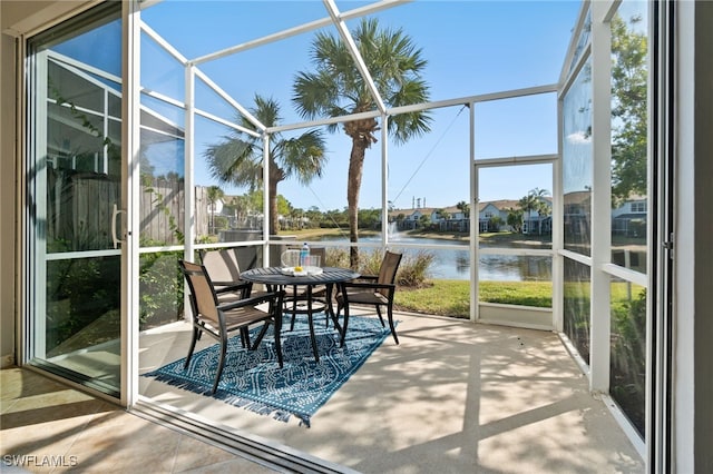 sunroom / solarium featuring a water view