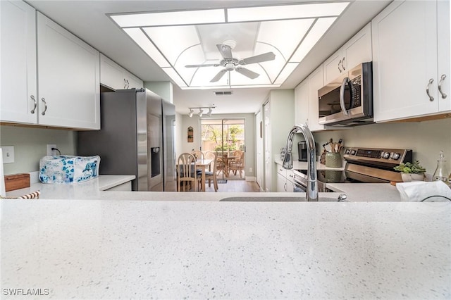 kitchen featuring white cabinetry, sink, ceiling fan, and appliances with stainless steel finishes