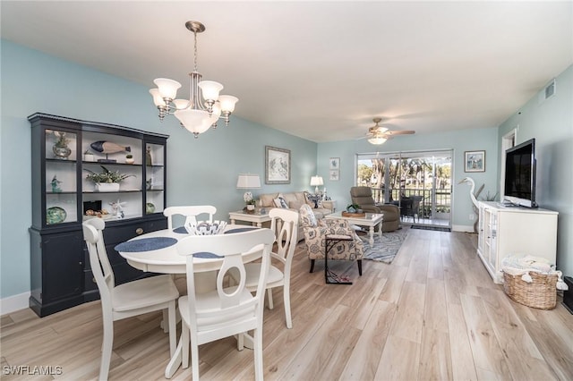 dining area featuring ceiling fan with notable chandelier and light wood-type flooring