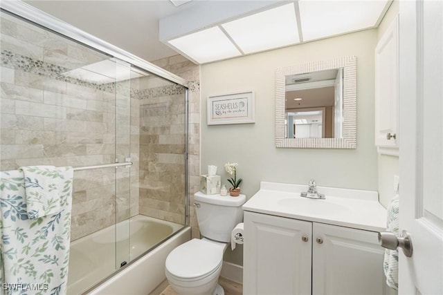 full bathroom with shower / bath combination with glass door, vanity, and toilet