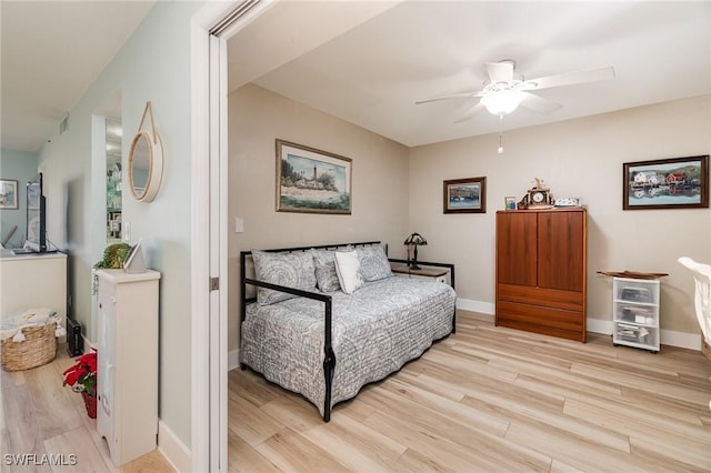 sitting room with ceiling fan and light hardwood / wood-style flooring