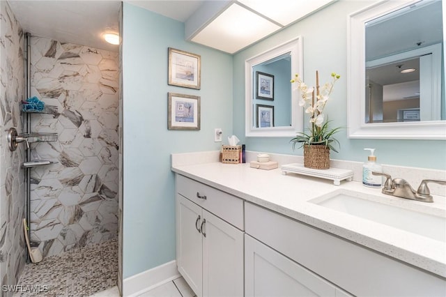 bathroom with vanity and tiled shower