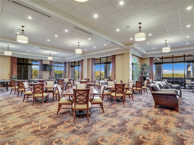 carpeted dining space with ornamental molding