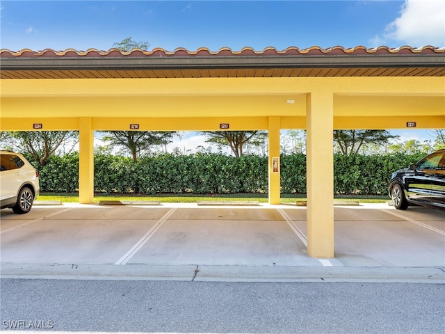 view of parking / parking lot featuring a carport