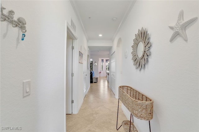 hallway featuring light tile patterned flooring and ornamental molding