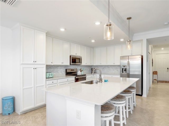 kitchen featuring sink, white cabinets, an island with sink, and appliances with stainless steel finishes