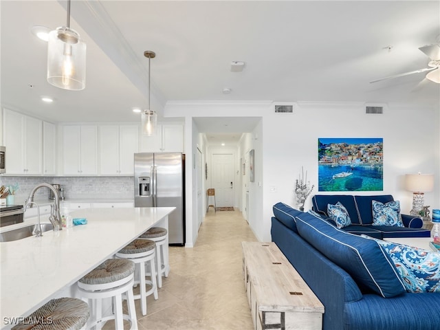 interior space featuring crown molding, sink, and ceiling fan