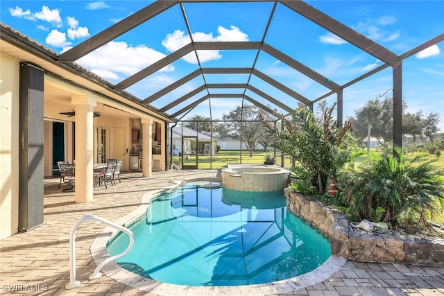 view of pool with glass enclosure, an in ground hot tub, a patio area, and ceiling fan