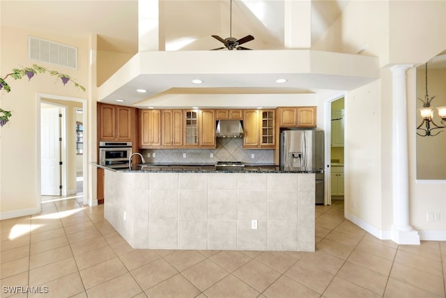 kitchen featuring appliances with stainless steel finishes, high vaulted ceiling, an island with sink, and extractor fan