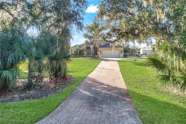 view of front of property featuring a front yard and a garage