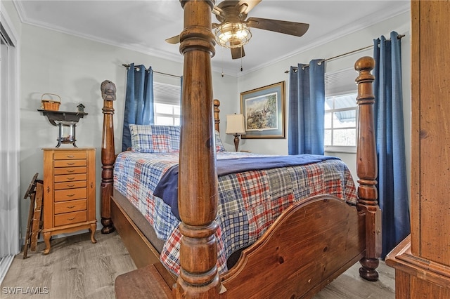 bedroom with ceiling fan, ornamental molding, and light hardwood / wood-style flooring