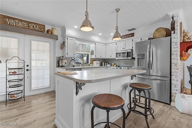 kitchen with light wood-type flooring, wood ceiling, stainless steel appliances, pendant lighting, and white cabinets