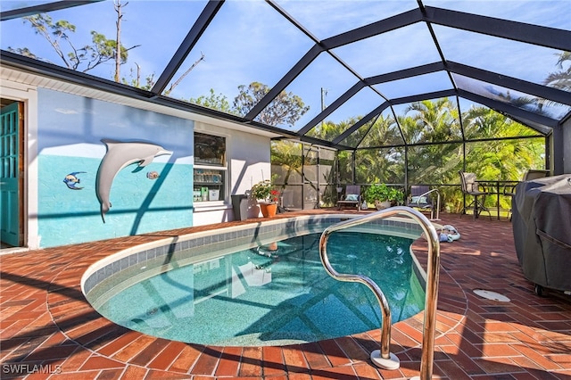 view of swimming pool with a lanai, a grill, and a patio area