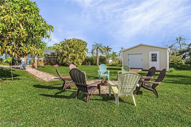 view of yard featuring an outdoor structure and an outdoor fire pit