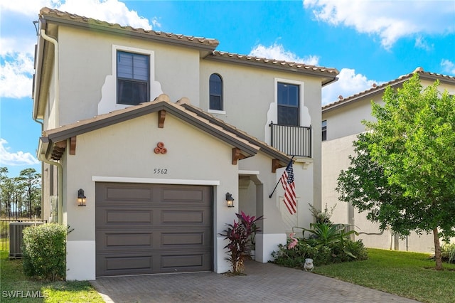 mediterranean / spanish home with cooling unit and a garage