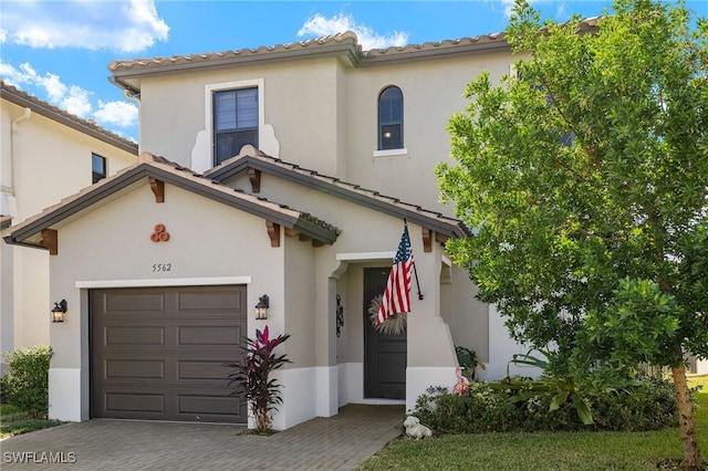 mediterranean / spanish home featuring a garage