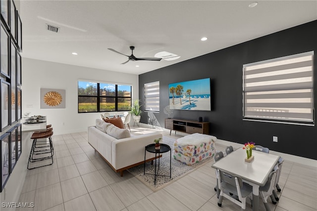 tiled living room with ceiling fan