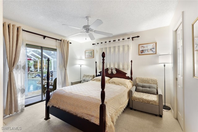 carpeted bedroom featuring access to exterior, a textured ceiling, and ceiling fan