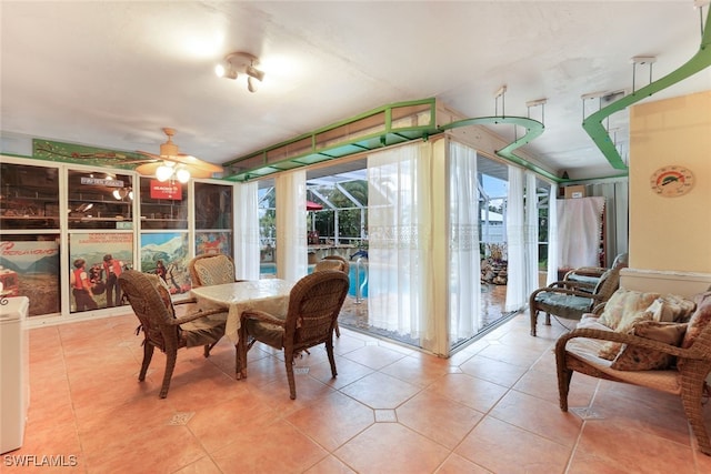 tiled dining room featuring ceiling fan